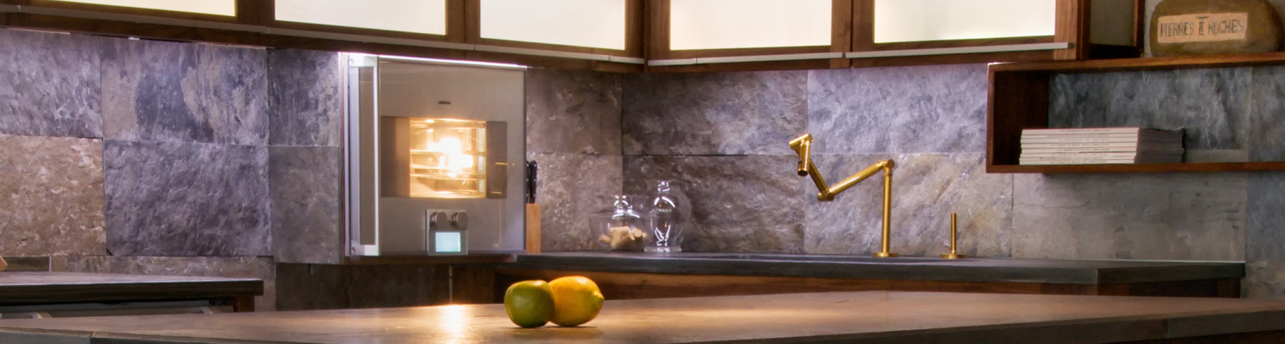 A kitchen with a counter made of high-quality slate and a sink.
