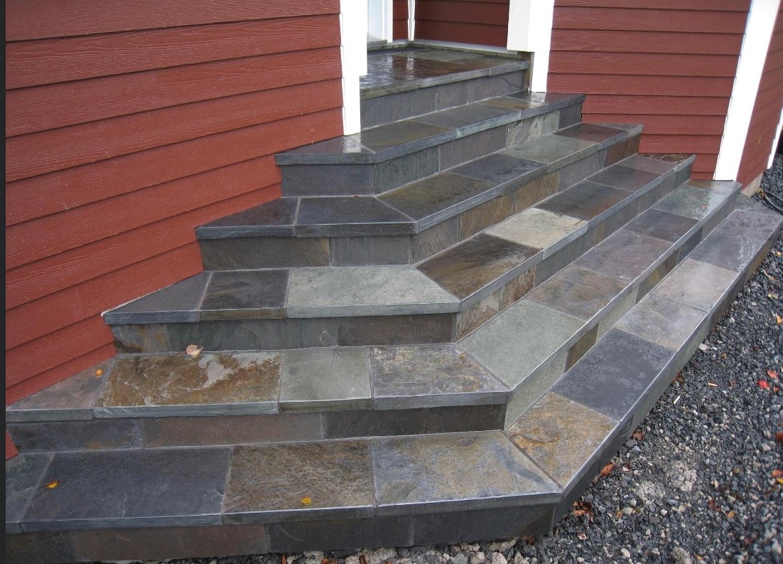 Entrance steps of a deep red-colored house
