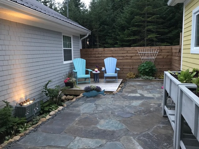 Backyard of a Home with Natural Stones and Easy Chairs